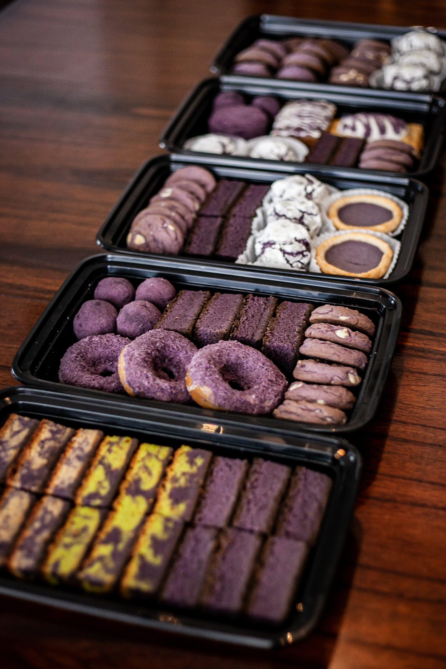 An assortment of purple sweet potato baked treats: cookies, brownies, donuts and more.