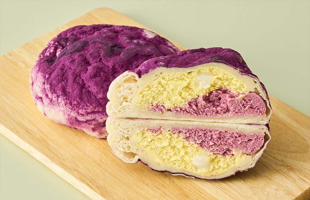Soft purple sweet potato cream bun with a colorful filling.