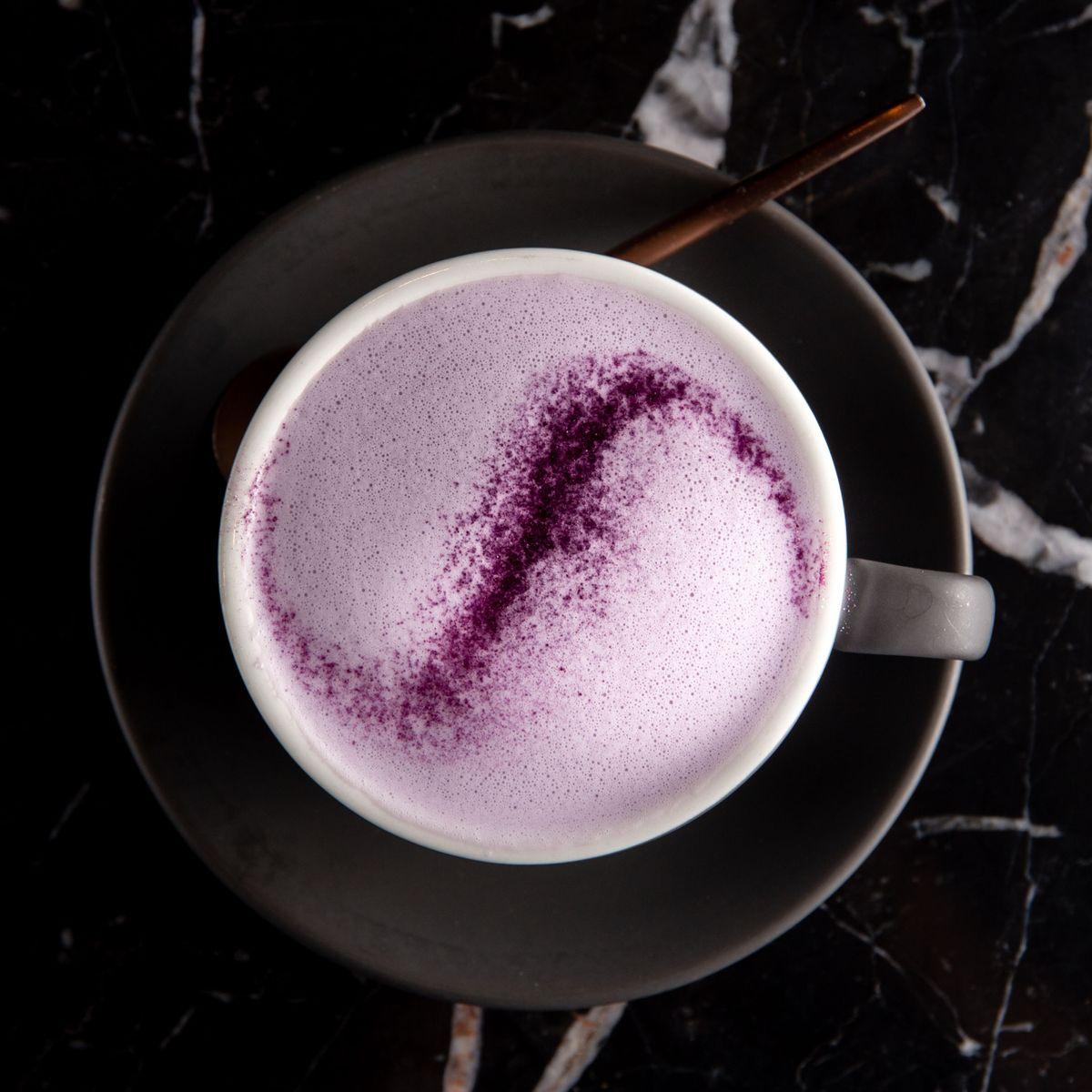 A warm purple sweet potato latte dusted with natural powder.